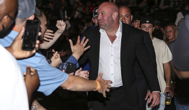 Dana White, president of the Ultimate Fighting Championship, greets fans during a UFC 261 mixed martial arts event, Saturday, April 24, 2021, in Jacksonville, Fla. It is the first UFC event since the onset of the COVID-19 pandemic to feature a full crowd in attendance. (AP Photo/Gary McCullough)