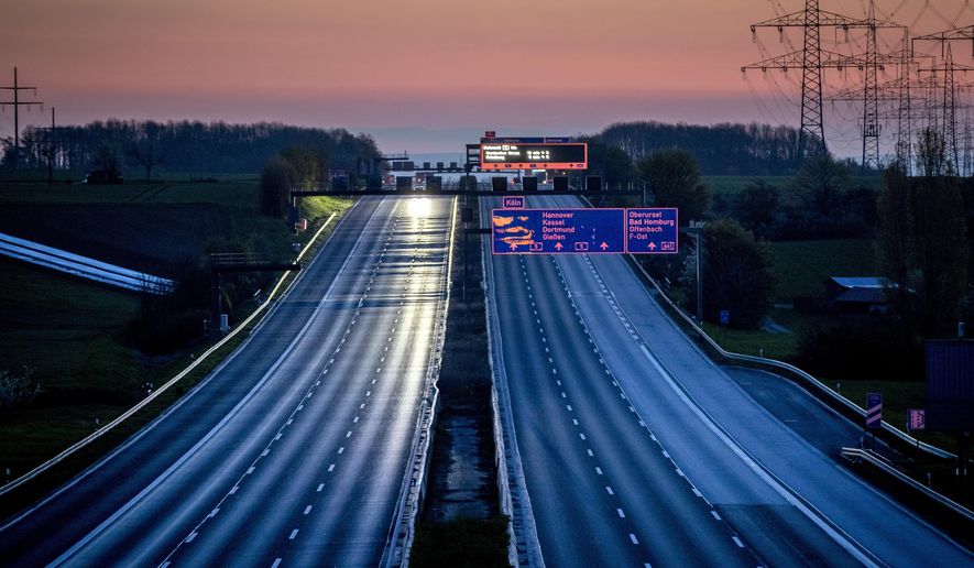 An almost empty highway is seen shortly after the end of the curfew in Frankfurt, Germany, Sunday, April 25, 2021. From the weekend on a curfew becomes effective to avoid the outspread of the coronavirus. (AP Photo/Michael Probst)