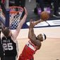 Washington Wizards guard Bradley Beal (3) goes to the basket against San Antonio Spurs center Jakob Poeltl (25) during overtime of an NBA basketball game, Monday, April 26, 2021, in Washington. The Spurs won 146-143. (AP Photo/Nick Wass)
