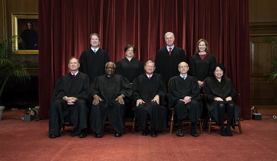 Members of the Supreme Court pose for a group photo at the Supreme Court in Washington. Seated from left are Associate Justice Samuel Alito, Associate Justice Clarence Thomas, Chief Justice John Roberts, Associate Justice Stephen Breyer and Associate Justice Sonia Sotomayor, Standing from left are Associate Justice Brett Kavanaugh, Associate Justice Elena Kagan, Associate Justice Neil Gorsuch and Associate Justice Amy Coney Barrett. (Erin Schaff/The New York Times via AP, Pool, File)