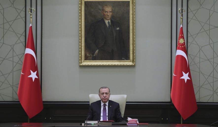 Turkey&#39;s President Recep Tayyip Erdogan, backdropped by a painting depicting modern Turkey&#39;s founder Mustafa Kemal Ataturk, chairs his government&#39;s cabinet in Ankara, Turkey, Monday, April 26, 2021. Erdogan said he was &quot;highly saddened&quot; by U.S. President Joe Biden&#39;s decision to mark as genocide the mass deportations and massacres of Armenians in the early 20th century Ottoman Empire, calling it baseless and unjust. (Turkish Presidency via AP)