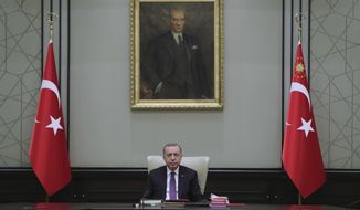Turkey&#39;s President Recep Tayyip Erdogan, backdropped by a painting depicting modern Turkey&#39;s founder Mustafa Kemal Ataturk, chairs his government&#39;s cabinet in Ankara, Turkey, Monday, April 26, 2021. Erdogan said he was &quot;highly saddened&quot; by U.S. President Joe Biden&#39;s decision to mark as genocide the mass deportations and massacres of Armenians in the early 20th century Ottoman Empire, calling it baseless and unjust. (Turkish Presidency via AP)