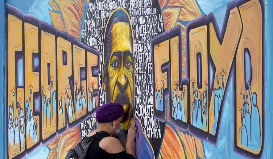 Damarra Atkins paid her respects to George Floyd at a mural at George Floyd Square, Friday, April 23, 2021, in Minneapolis. (AP Photo/Julio Cortez)