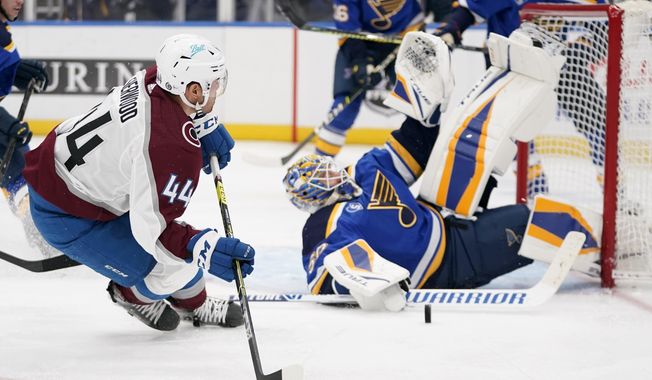 Colorado Avalanche&#x27;s Kiefer Sherwood (44) is unable to score past St. Louis Blues goaltender Jordan Binnington, right, during the third period of an NHL hockey game Monday, April 26, 2021, in St. Louis. (AP Photo/Jeff Roberson)