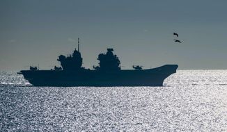 FILE - In this Feb. 9, 2018, file photo, the 65,000-tonne HMS Queen Elizabeth, the largest warships ever built for the Royal Navy of the United Kingdom, arrives at the British territory of Gibraltar. New aircraft carrier HMS Queen Elizabeth, the most powerful surface vessel in the Royal Navy&#39;s history, will set sail in May 2021 for Asia with eight fast jets on board. It will be accompanied by six Royal Navy ships, a submarine armed with Tomahawk cruise missiles, 14 naval helicopters and a company of Royal Marines. (AP Photo/Marcos Moreno, File)