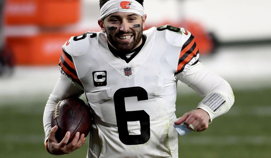 FILE - In this Jan. 10, 2021, file photo, Cleveland Browns quarterback Baker Mayfield runs off the field after defeating the Pittsburgh Steelers in an NFL wild-card playoff football game in Pittsburgh. Mayfield&#x27;s offseason included running, lifting, getting a guaranteed $18 million and a celestial close encounter he will not forget. On his way home from dinner in Texas last month with his wife, Emily, Mayfield said he saw a UFO. (AP Photo/Justin Berl, File)