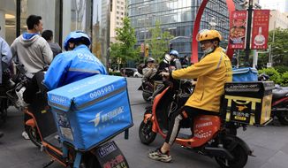 A Meituan delivery man in yellow goes on his rounds in Shanghai on Wednesday, April 21, 2021. China&#39;s market regulator on Monday, April 26, 2021 said it launched an investigation into suspected monopolistic behavior by food delivery firm Meituan, months after it investigated e-commerce company Alibaba as Beijing steps up scrutiny of anti-competitive behavior in the internet sector. (AP Photo/Ng Han Guan)