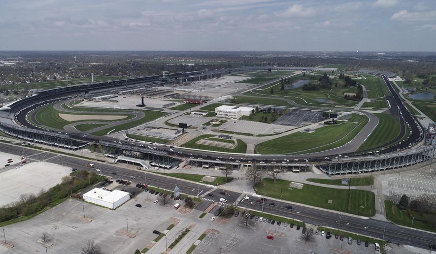 Police vehicles line the track at Indianapolis Motor Speedway Thursday, April 16, 2020, before the funeral of slain Indianapolis Metropolitan Police Department Officer Breann Leath. There are more than 300 acres inside the gates of the Indianapolis Motor Speedway, enough room to fit Vatican City, Yankee Stadium, The White House, Liberty Island, the Taj Majal, Roman Colosseum, Churchill Downs and the Rose Bowl. All at the same time. So if there&#39;s a facility that can safely host 135,000 fans during a pandemic, it would be Indianapolis. The speedway has been approved to host 40% its capacity for the Indy 500 next month, which will make it the largest sporting event since the start of the pandemic. (The Indianapolis Star via AP)