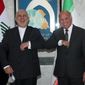 Iraqi Foreign Minister Fouad Hussein, right, meets with visiting Iranian counterpart Mohammad Javad Zarif in Baghdad, Iraq, Monday, April 26, 2021. (AP Photo/Khalid Mohammed)