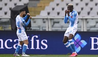 Napoli&#39;s Victor Osimhen, right, celebrates with Lorenzo Insigne after scoring his side&#39;s 2nd goal, during the Serie A soccer match between Torino and Napoli, at the Olympic stadium in Turin, Italy, Monday, April 26, 2021. (Fabio Ferrari/LaPresse via AP)