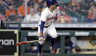 Houston Astros&#x27; Jose Altuve flips his bat as he watches his two-run RBI single against the Seattle Mariners during the fourth inning of a baseball game Monday, April 26, 2021, in Houston. This game is the return to play for Altuve after being diagnosed with COVID-19. (AP Photo/Michael Wyke)