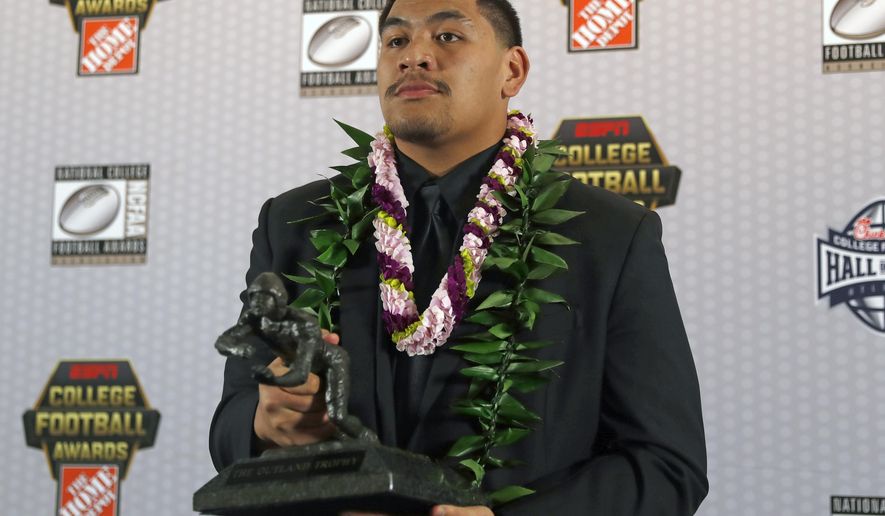 FILE - In this Dec. 12, 2019, file photo, Oregon&#39;s Penei Sewell poses with Outland Trophy for being the nation&#39;s best interior lineman, in Atlanta. Sewell is a likely first round pick in the NFL Draft, April 29-May 1, 2021, in Cleveland.(AP Photo/John Bazemore, File)