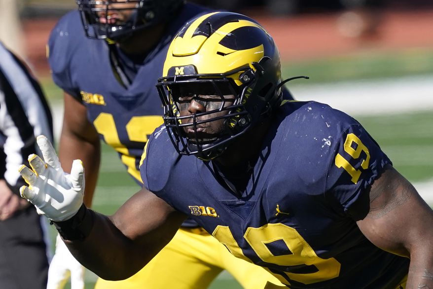 FILE - Michigan defensive lineman Kwity Paye is shown during the second half of an NCAA college football game against Michigan State in Ann Arbor, Mich., in this Saturday, Oct. 31, 2020, file photo. Paye is a possible first round pick in the NFL Draft, April 29-May 1, 2021, in Cleveland. (AP Photo/Carlos Osorio, File)
