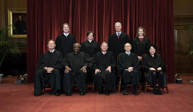 In this April 23, 2021, file photo members of the Supreme Court pose for a group photo at the Supreme Court in Washington. Seated from left are Associate Justice Samuel Alito, Associate Justice Clarence Thomas, Chief Justice John Roberts, Associate Justice Stephen Breyer and Associate Justice Sonia Sotomayor, Standing from left are Associate Justice Brett Kavanaugh, Associate Justice Elena Kagan, Associate Justice Neil Gorsuch and Associate Justice Amy Coney Barrett. Before the Supreme Court this is week is an argument over whether public schools can discipline students over something they say off-campus. (Erin Schaff/The New York Times via AP, Pool, File)
