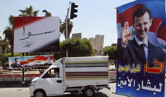 FILE - In this May 12, 2014 file photo, campaign posters for the upcoming presidential election adorn a street in Damascus, Syria. On Monday April 26, 2021, the Paris-based Syrian Network for Human Rights called on the international community to reject presidential elections in the war-torn country scheduled for May, describing them as a sham because they will take place under President Bashar Assad, who is implicated in war crimes. Arabic on the poster, right, reads, &amp;quot;Damascus spreads flowers for the loyal Bashar.&amp;quot; The banner reads, &amp;quot;Together with Bashar Assad.&amp;quot; (AP Photo, File)