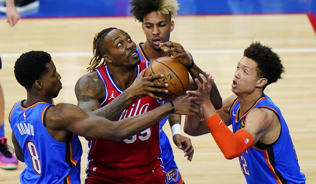 Philadelphia 76ers&#x27; Dwight Howard, second from left, tries to go up for a shot against Oklahoma City Thunder&#x27;s Jaylen Hoard, from left, Charles Brown Jr. and Isaiah Roby during the second half of an NBA basketball game, Monday, April 26, 2021, in Philadelphia. (AP Photo/Matt Slocum)