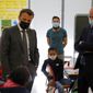 French President Emmanuel Macron talks with pupils during a visit with French Education, Youth and Sports Minister Jean-Michel Blanquer, right, in a school in Melun, south of Paris, Monday, April 26, 2021. Nursery and primary schools reopened on Monday across France after a three-week closure in the first step out of the country&#39;s partial lockdown. Meanwhile, high schools students are following online classes. (AP Photo/Thibault Camus, pool)