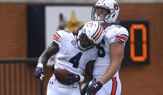Auburn running back Tank Bigsby (4) celebrates a touchdown with teammate Luke Deal (86) during the A-Day spring football game Saturday, April 17, 2021, at Jordan-Hare Stadium in Auburn, Ala. (AP Photo/Julie Bennett)