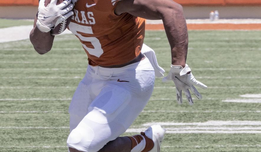 FILE - Texas running back Bijan Robinson (5) runs during the final half of the Texas Orange and White Spring Scrimmage in Austin, Texas, in this Saturday, April 24, 2021, file photo. No player frustrated Texas fans last season more than tailback Bijan Robinson. Not because of anything he did, but because of Herman’s odd refusal to give him the ball more often. (AP Photo/Michael Thomas, File)
