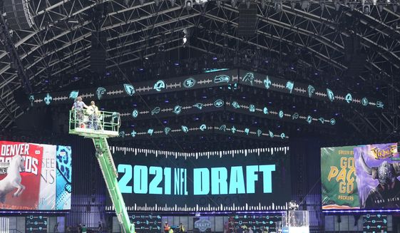 Workers continue preparing the NFL Draft Theatre for the 2021 NFL Draft, Tuesday, April 27, 2021, in Cleveland. After going all virtual in 2020 due to the COVID-19 pandemic, the three-day draft, which has grown into one of America&#39;s biggest, non-game sporting events, returns with thousands of fans who will be separated by their loyalties, and whether they&#39;ve been vaccinated.(AP Photo/Tony Dejak)