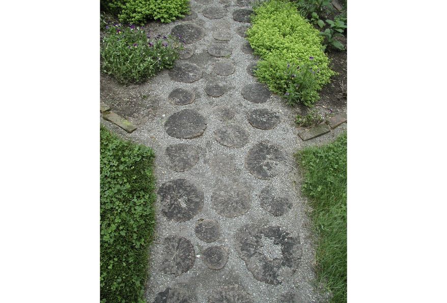 This undated photo shows a garden path in South Salem, NY, NY. This locust wood and gravel path is attractive even as it provides firm footing even in wet weather. (Lee Reich via AP)