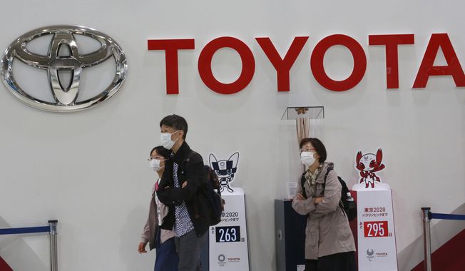 FILE - In this Nov. 2, 2020, file photo, visitors walk at a Toyota showroom in Tokyo. Toyota Motor Corp. has acquired the self-driving division of American ride-hailing company Lyft for $500 million, in a move that underlines the Japanese automaker’s ambitions in that technology, announced Tuesday, April 27, 2021. (AP Photo/Koji Sasahara, File)