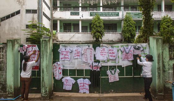 Activists and anti-coup protesters hang student uniforms on the wall of a school during a demonstration against the reopening of the school by the government in Yangon, Myanmar, Tuesday, April 27, 2021. Demonstrations have continued in many parts of the country since Saturday&#39;s meeting of leaders from the Association of Southeast Asian Nations, as have arrests and beatings by security forces despite an apparent agreement by junta leader Senior Gen. Min Aung Hlaing to end the violence. (AP Photo)