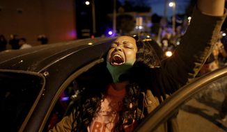 A demonstrator yells from her car as protesters took to the streets in Elizabeth City, N.C., on Monday, April 26, 2021, to protest the killing of Andrew Brown by police and to demand the full body camera footage be released. (Stephen M. Katz/The Virginian-Pilot via AP)