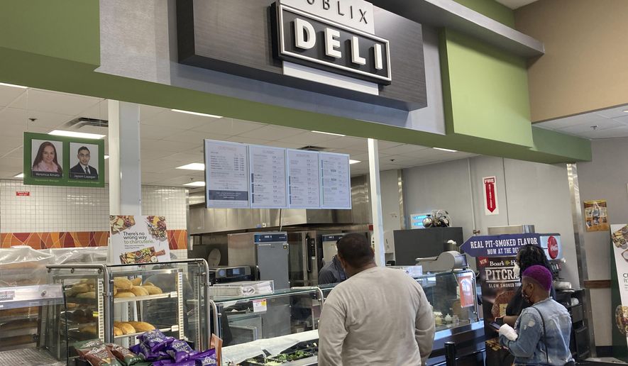 Clients wait to order lunch at the Publix Supermarket Deli in Miami Shores, Fla., Tuesday April 27, 2021. A popular Twitter account that notified people when Publix chicken-tender subs were on sale has been abandoned after lawyers for the Florida-based grocery chain apparently objected. The account "Are Publix Chicken Tender Subs On Sale?" – with nearly 40,000 followers – has been dormant since March 11. (AP Photo/Marta Lavandier)