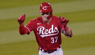Cincinnati Reds&#39; Tyler Stephenson gestures toward his bench after hitting a double during the fourth inning of a baseball game against the Los Angeles Dodgers Monday, April 26, 2021, in Los Angeles. (AP Photo/Mark J. Terrill)