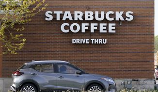 A customers exits the drive thru lane at a Starbucks coffee shop, Tuesday, April 27, 2021, in Des Moines, Iowa. After four straight quarters of sales declines, Starbucks returned to growth in the January-March period. (AP Photo/Charlie Neibergall)