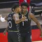Minnesota Timberwolves guard D&#39;Angelo Russell (0) and forward Anthony Edwards (1) celebrate the team&#39;s win over the Houston Rockets in an NBA basketball game Tuesday, April 27, 2021, in Houston. (Thomas Shea/Pool Photo via AP)