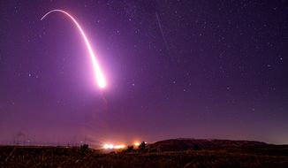 This image taken with a slow shutter speed on Oct. 2, 2019, and provided by the U.S. Air Force shows an unarmed Minuteman 3 intercontinental ballistic missile test launch at Vandenberg Air Force Base, Calif.  (Associated Press/File)  **FILE**