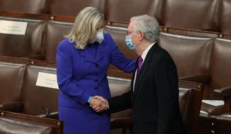 House Republican Conference Chairperson Rep. Liz Cheney, R-Wyo., shakes hands with Senate Minority Leader Mitch McConnell of Kentucky, on the House floor as they await President Joe Biden to arrive to address a joint session of Congress, Wednesday, April 28, 2021, in the House Chamber at the U.S. Capitol in Washington. (Jonathan Ernst/Pool via AP)
