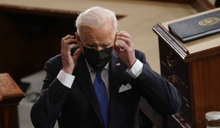 President Joe Biden puts his face mask on after speaking to a joint session of Congress Wednesday, April 28, 2021, in the House Chamber at the U.S. Capitol in Washington. (AP Photo/Andrew Harnik, Pool) ** FILE **