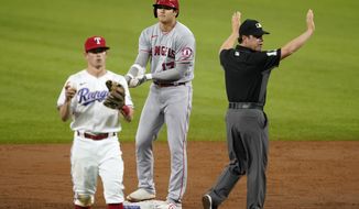Texas Rangers second baseman Nick Solak throws the ball in as Los Angeles Angels&#39; Shohei Ohtani stands on second with a double to left in the second inning of a baseball game in Arlington, Texas, Wednesday, April 28, 2021. Umpire D.J. Reyburn signals to the field after the play. (AP Photo/Tony Gutierrez)