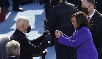 FILE - In this Jan. 20, 2021, file photo President-elect Joe Biden congratulates Vice President Kamala Harris after she was sworn in during the 59th Presidential Inauguration at the U.S. Capitol in Washington. Biden will mark his 100th day in office on Thursday, April 29. (AP Photo/Carolyn Kaster, File)