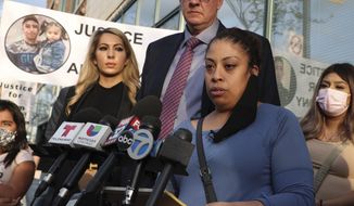 Veronica Alvarez, foreground, the mother of 22-year-old Anthony Alvarez, reads a statement to the media on Tuesday, April 27, 2021, after watching video of her son&#39;s fatal shooting. Her attorney Todd Pugh stands behind her. (Terrence Antonio James/Chicago Tribune via AP)