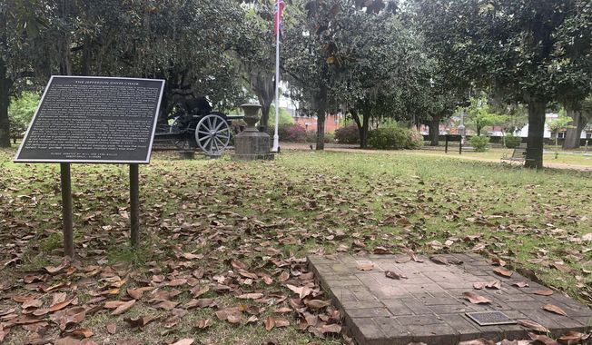 A brick base sits empty Tuesday, April 13, 2021, where chair carved out of limestone honoring Confederate President Jefferson Davis was stolen from Confederate Memorial Circle, a private section of Live Oak Cemetery in Selma, Ala. Police recovered the chair in New Orleans. (AP Photo/Kim Chandler)