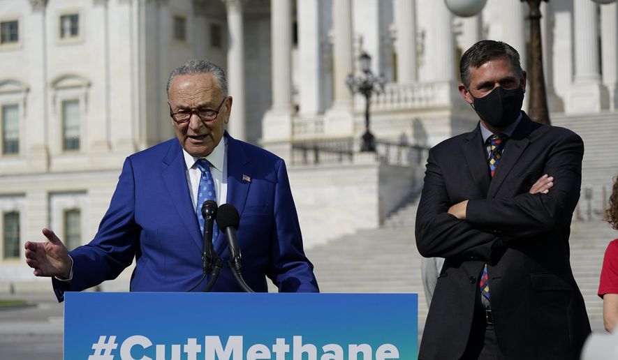 Senate Majority Leader Chuck Schumer, D-N.Y., joined by Sen. Martin Heinrich, D-N.M., right, talks about legislation to re-impose critical regulations to reduce methane pollution from oil and gas wells, at the Capitol in Washington, Wednesday, April 28, 2021. (AP Photo/J. Scott Applewhite)
