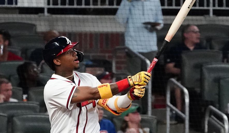 Atlanta Braves' Ronald Acuna Jr. watches his solo home run during the fifth inning of the team's baseball game against the Chicago Cubs on Tuesday, April 27, 2021, in Atlanta. (AP Photo/John Bazemore)