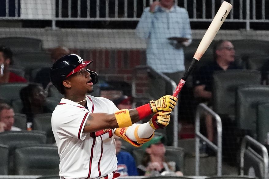 Atlanta Braves' Ronald Acuna Jr. watches his solo home run during the fifth inning of the team's baseball game against the Chicago Cubs on Tuesday, April 27, 2021, in Atlanta. (AP Photo/John Bazemore)