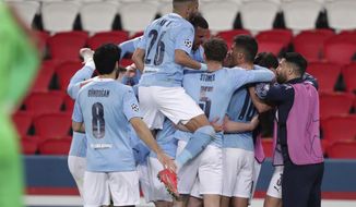 Manchester City&#39;s Kevin De Bruyne, 2nd left, celebrates with teammates after scoring his sides first goal during the Champions League semifinal first leg soccer match between Paris Saint Germain and Manchester City at the Parc des Princes stadium, in Paris, France , Wednesday, April 28, 2021. (AP Photo/Thibault Camus)