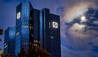 FILE — In this Oct. 4, 2020, file photo, the moon shines next to the headquarters of the Deutsche Bank in Frankfurt, Germany. Deutsche Bank releases first-quarter earnings on Wednesday. (AP Photo/Michael Probst, File)