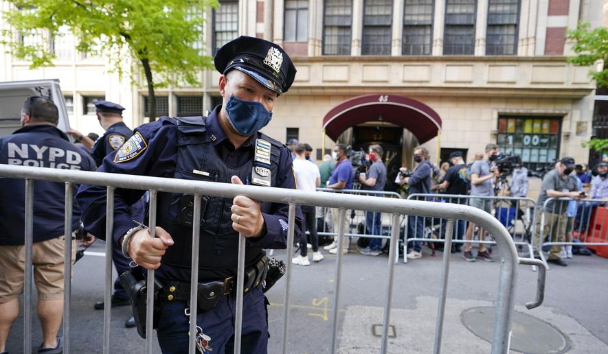 New York City police officers set up barricades to contain members of the media outside the building where Rudy Giuliani lives, Wednesday, April 28, 2021, in New York. A law enforcement official tells The Associated Press that federal investigators have executed search warrants at Rudy Giuliani’s Manhattan residence and office. The former New York City mayor has been under investigation for several years over his business dealings in Ukraine. Details of the reasons for Wednesday&#39;s searches were not immediately available. (AP Photo/Mary Altaffer)