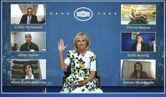 In this image from video provided by The White House, first lady Jill Biden waves to her virtual guests on Wednesday, April 28, 2021, ahead of the joint session of Congress and President Joe Biden&#39;s speech in Washington. Guests watching virtually will include, Javier Quiroz Castro, Maria-Isabel Ballivian, Tatiana Washington, Stella Keating, and Theron Rutyna. (White House via AP)