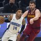 Orlando Magic&#39;s Gary Harris (14) drives past Cleveland Cavaliers&#39; Kevin Love during the first quarter of an NBA basketball game Wednesday, April 28, 2021 in Cleveland. (AP Photo/Phil Long)
