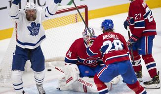 Toronto Maple Leafs&#39; Joe Thornton (97) celebrates a goal against Montreal Canadiens goaltender Jake Allen (34) as Canadiens&#39; Jon Merrill (28) and Alexander Romanov (27) look on during the second period of an NHL hockey game Wednesday, April 28, 2021, in Montreal. (Ryan Remiorz/The Canadian Press via AP)