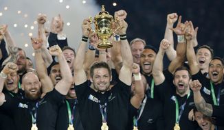 FILE - In this Oct. 31, 2015, file photo, New Zealand&#39;s captain Richie McCaw holds the trophy aloft after the Rugby World Cup final between New Zealand and Australia at Twickenham Stadium in London. The All Blacks won 34-17. New Zealand Rugby will face a momentous decision on the future of the All Blacks at its annual meeting Thursday, April 29, 2021, when it debates whether to sell a stake in the commercial value of the national team to American investors. (AP Photo/Christophe Ena, File)