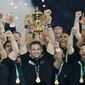 FILE - In this Oct. 31, 2015, file photo, New Zealand&#39;s captain Richie McCaw holds the trophy aloft after the Rugby World Cup final between New Zealand and Australia at Twickenham Stadium in London. The All Blacks won 34-17. New Zealand Rugby will face a momentous decision on the future of the All Blacks at its annual meeting Thursday, April 29, 2021, when it debates whether to sell a stake in the commercial value of the national team to American investors. (AP Photo/Christophe Ena, File)